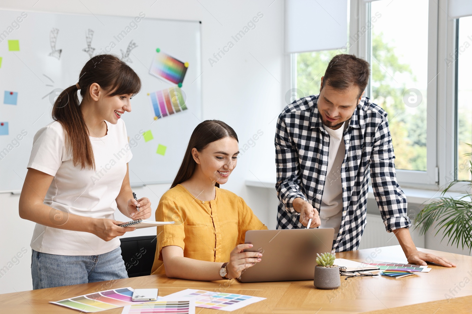 Photo of Group of designers working together in office