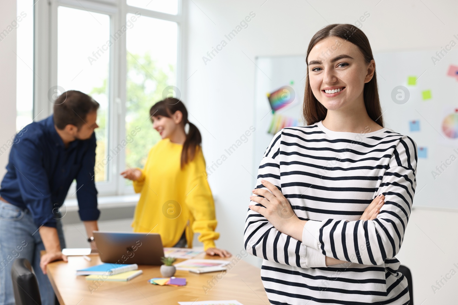 Photo of Portrait of happy young designer in office