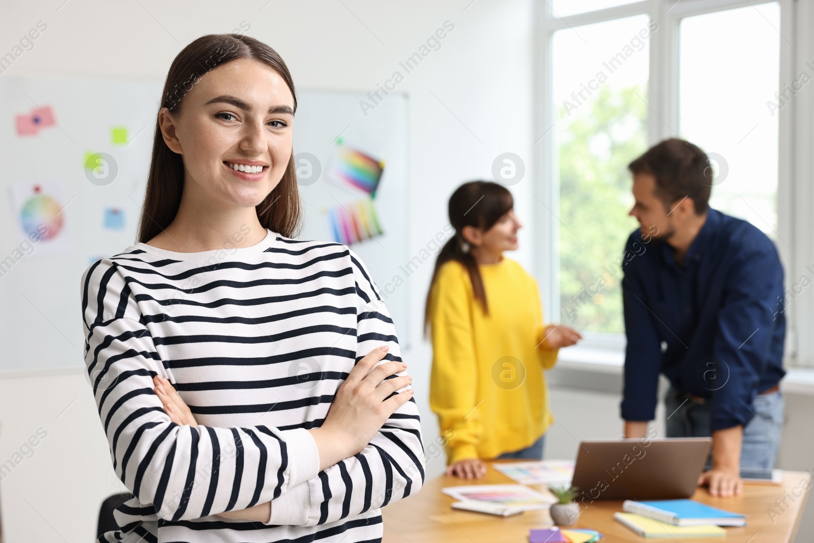 Photo of Portrait of happy young designer in office