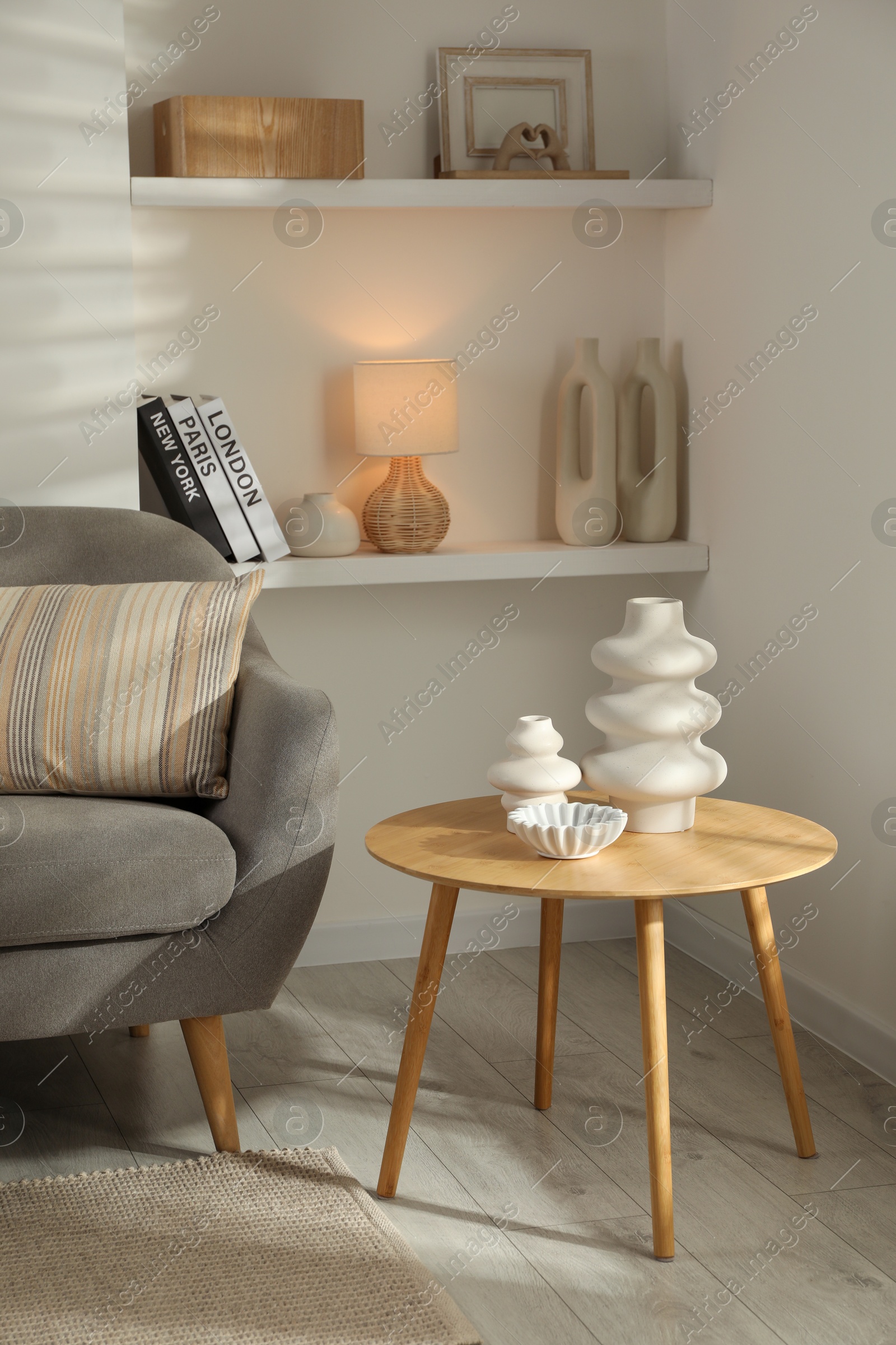 Photo of Sofa with soft cushion and coffee table in living room. Interior design