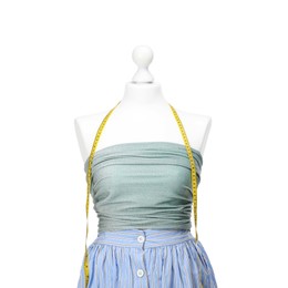 Photo of Mannequin with skirt, shirt and measuring tape isolated on white. Creating new outfit