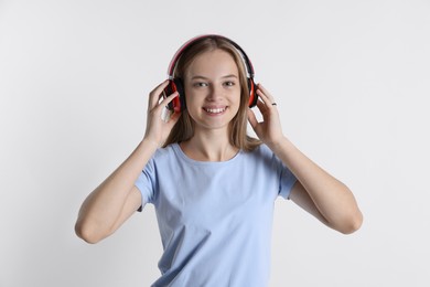 Photo of Teenage girl in headphones on white background