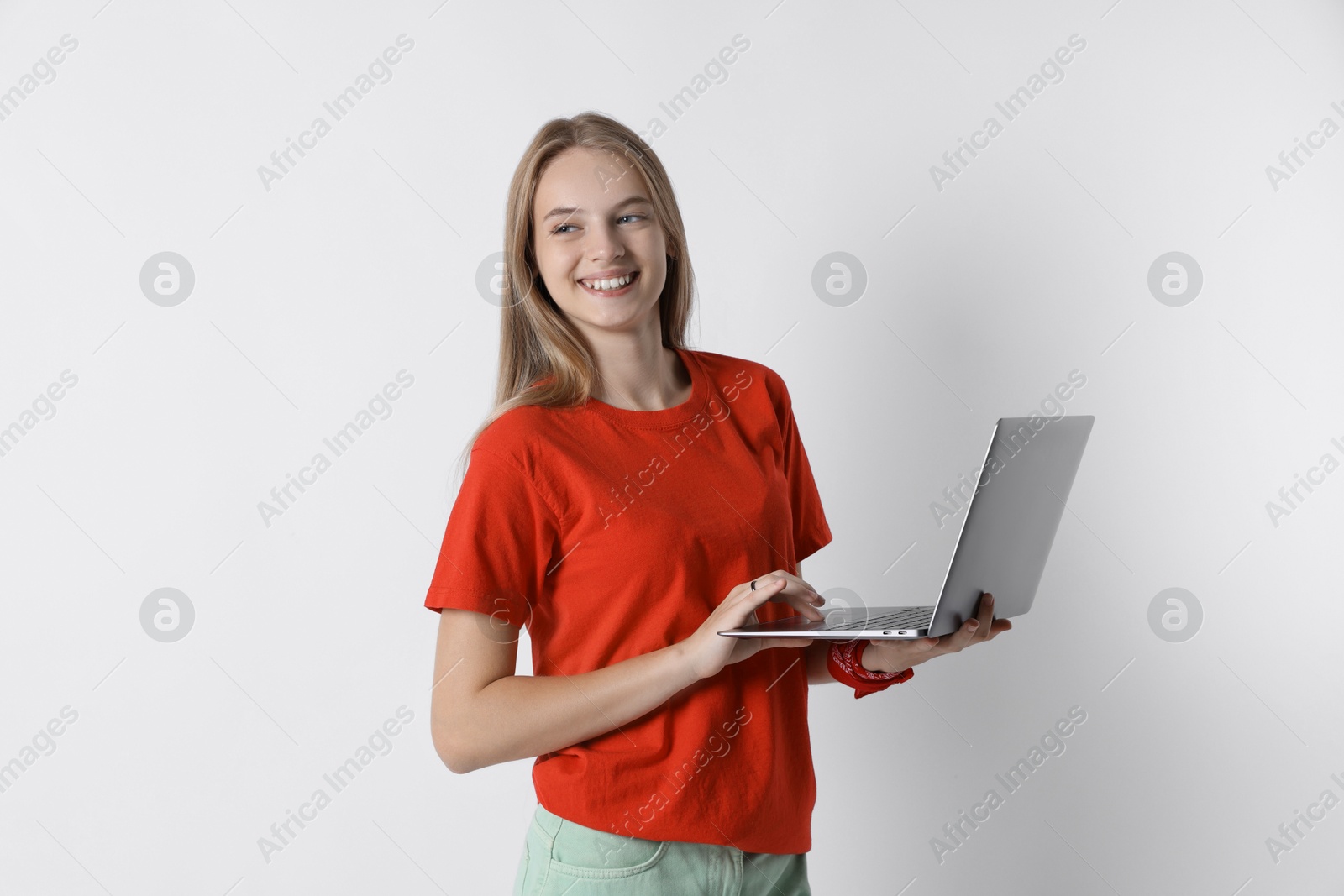 Photo of Teenage girl using laptop on white background