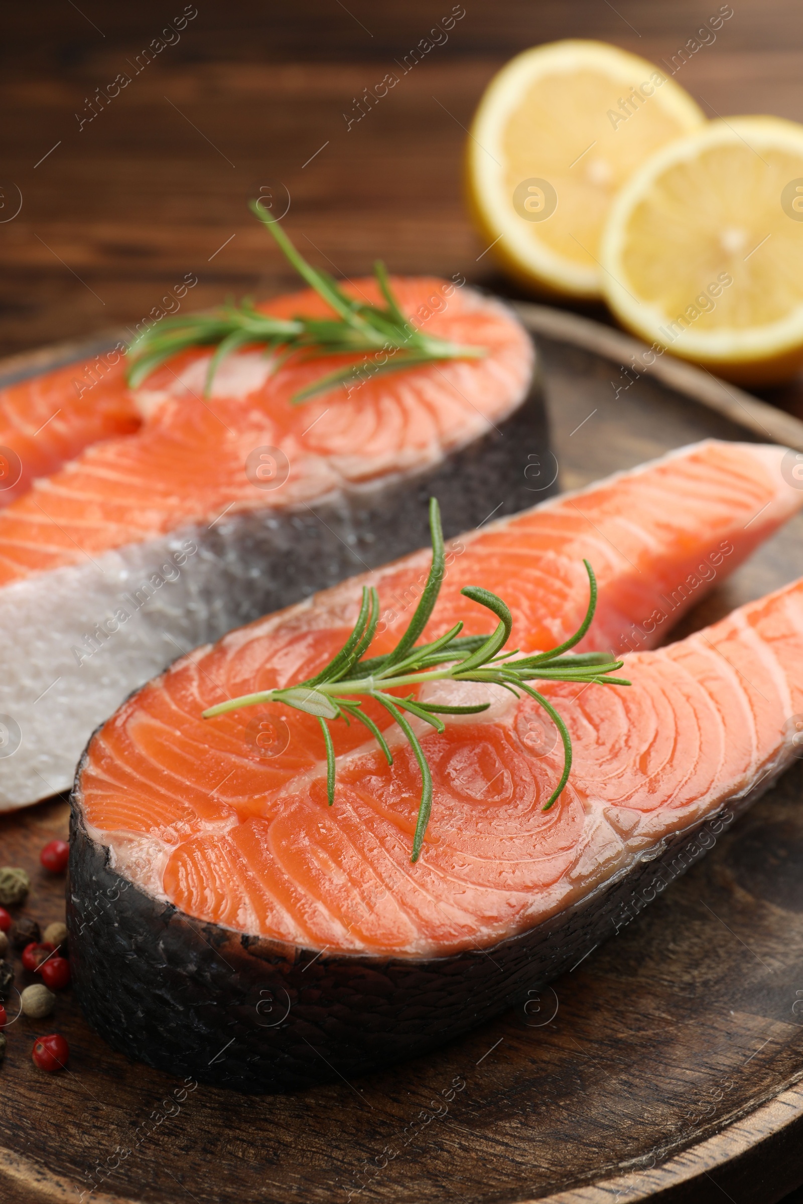 Photo of Fresh raw salmon steaks and spices on table, closeup