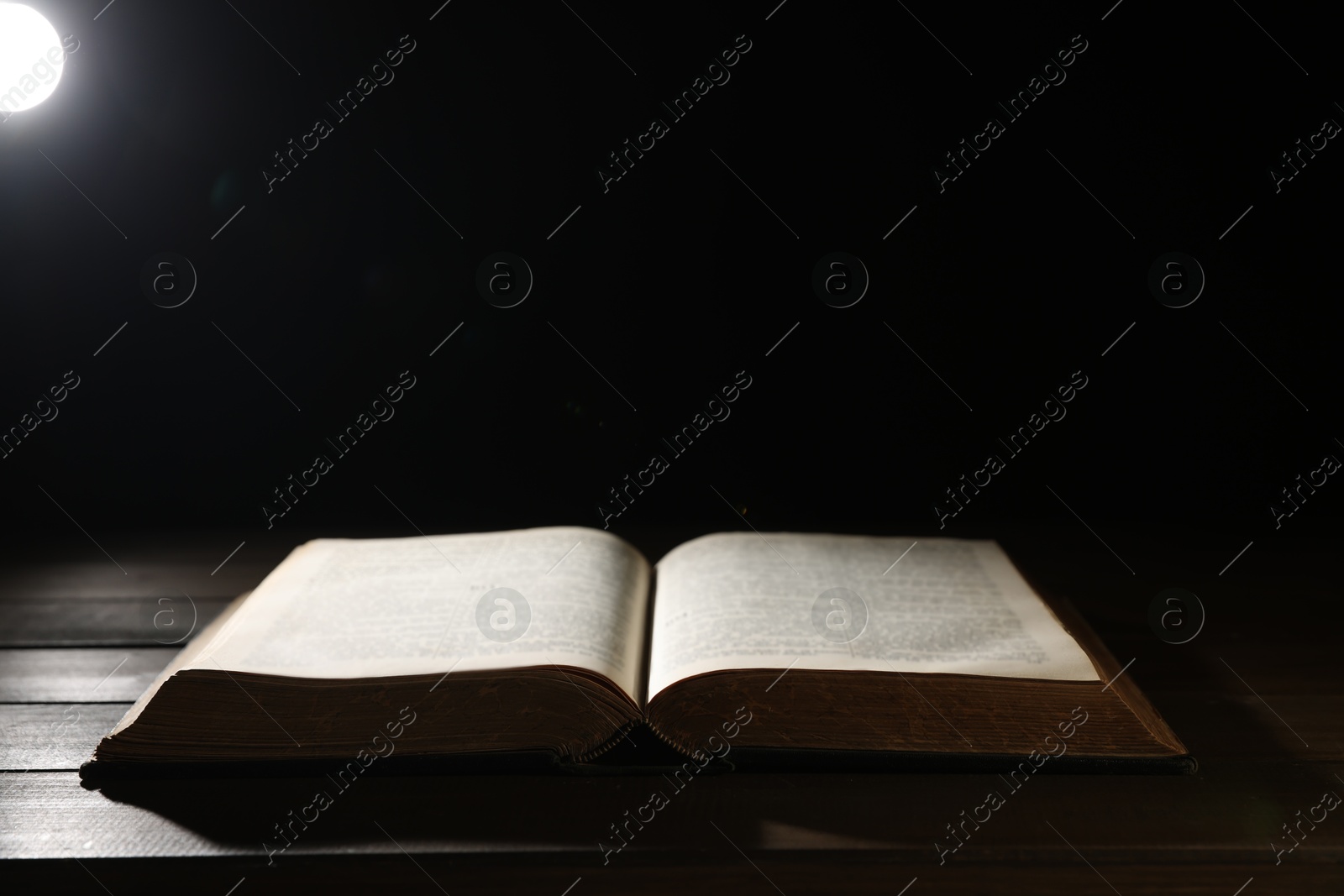 Photo of Open Bible on wooden table. Christian faith