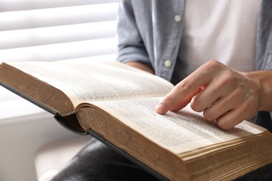 Photo of Man with Bible indoors, closeup. Christian faith