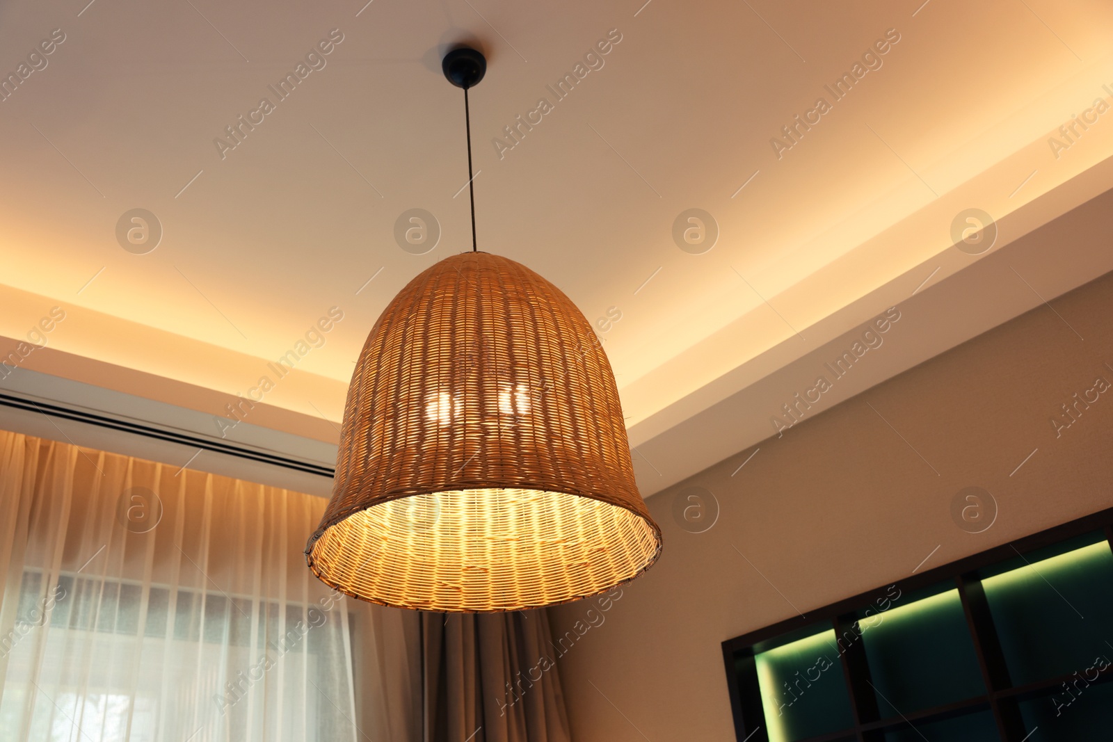 Photo of Stylish pendant lamp on ceiling indoors, low angle view