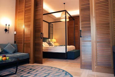 Photo of Stylish wooden sliding doors in hotel room