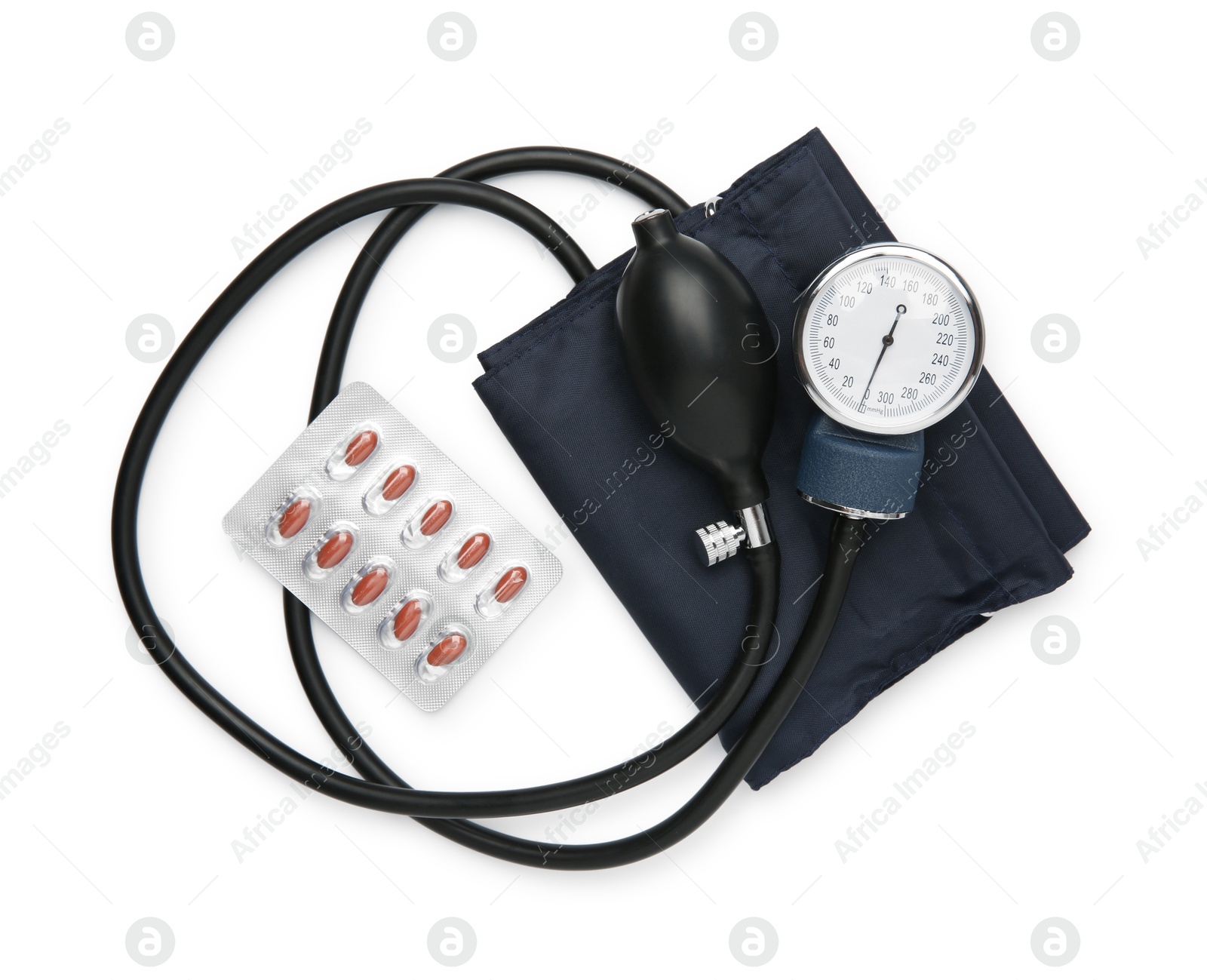 Photo of Blood pressure measuring device and pills in blister isolated on white, top view