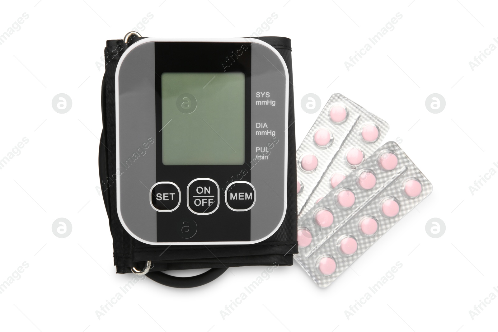 Photo of Blood pressure monitor and pills in blisters isolated on white, top view