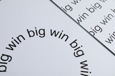 Photo of Sheets of paper with words Big win on grey table, closeup