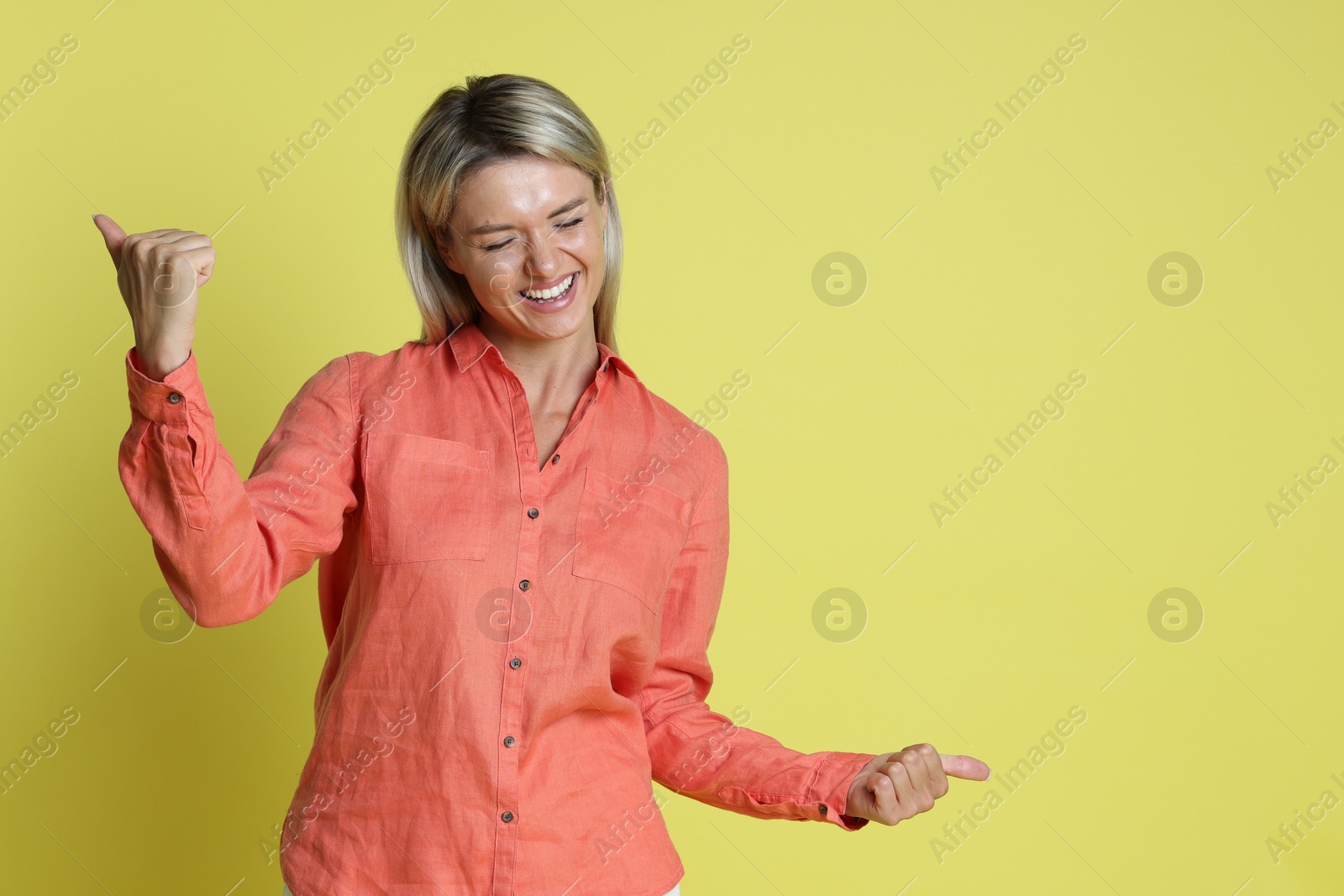 Photo of Happy winner on yellow background, space for text