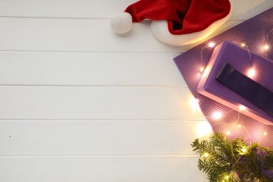 Photo of Flat lay composition with yoga mat and Christmas decor on white wooden background, space for text