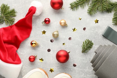 Photo of Flat lay composition with yoga mat and Christmas decor on gray textured background