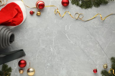 Photo of Flat lay composition with yoga mat and Christmas decor on gray textured background, space for text