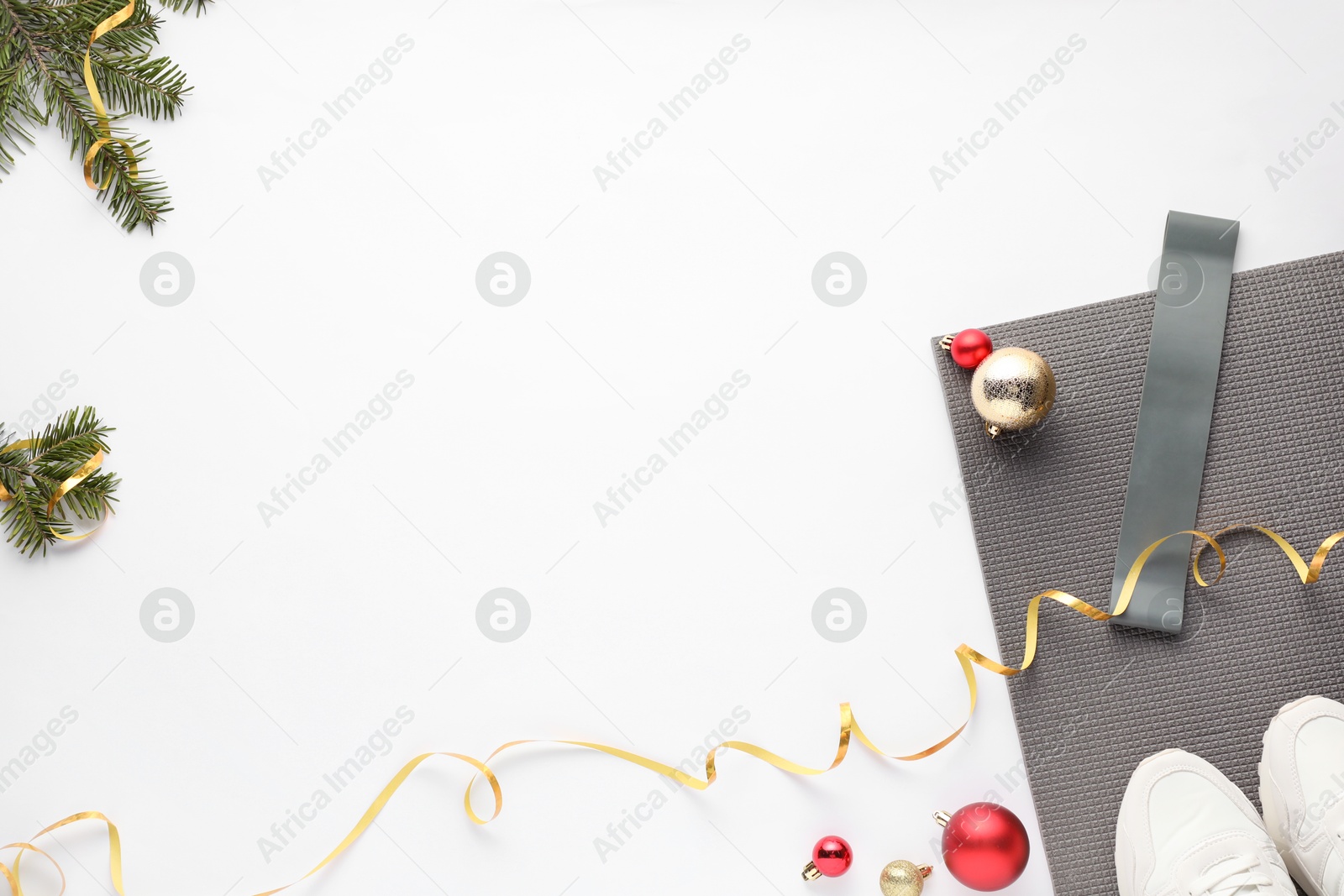 Photo of Flat lay composition with yoga mat and Christmas decor on white background, space for text