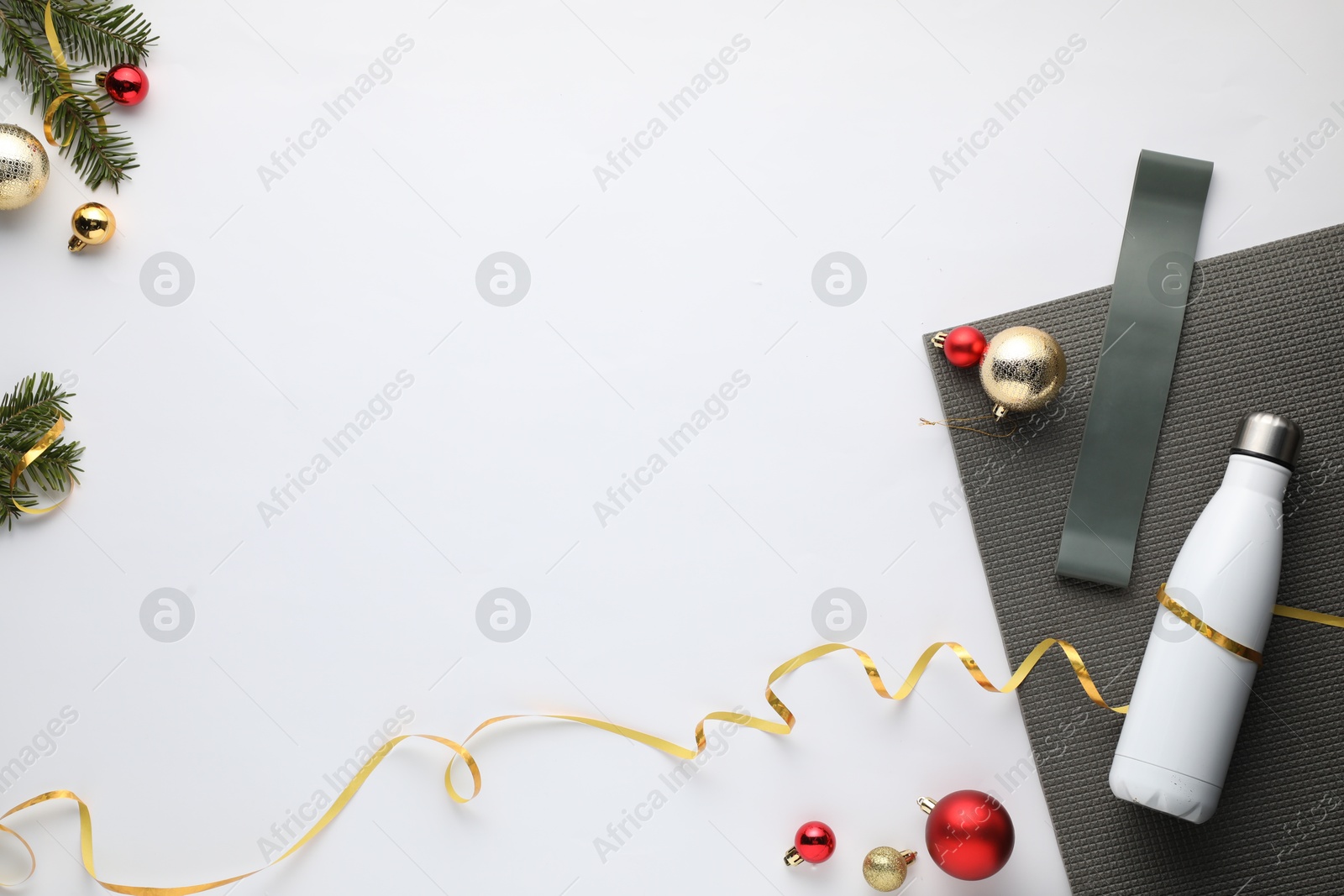 Photo of Flat lay composition with yoga mat and Christmas decor on white background, space for text