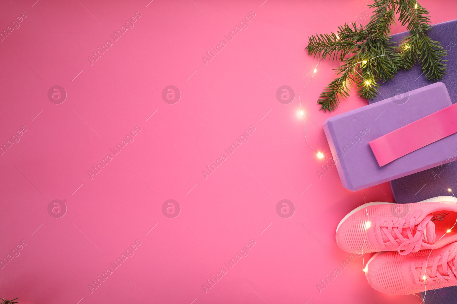 Photo of Flat lay composition with yoga mat and Christmas decor on pink background, space for text