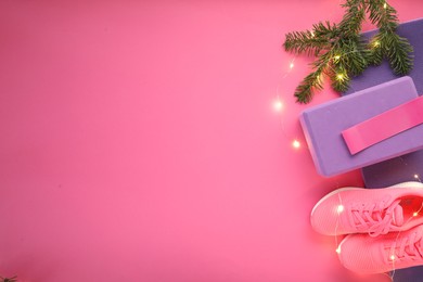 Photo of Flat lay composition with yoga mat and Christmas decor on pink background, space for text