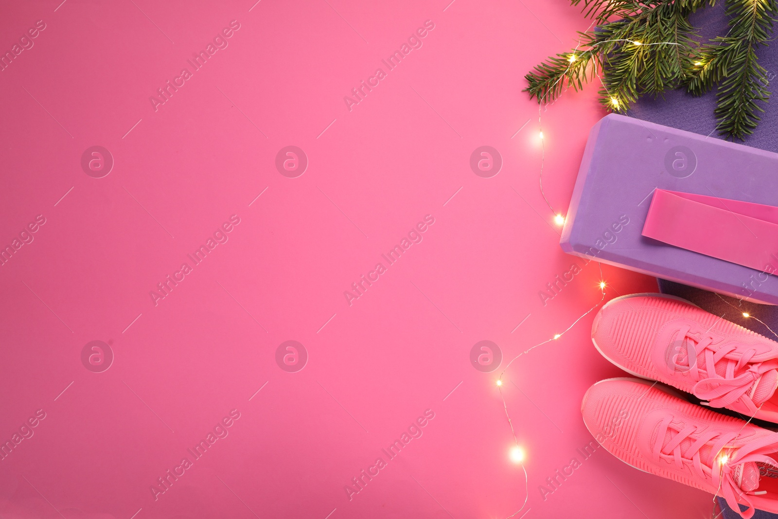 Photo of Flat lay composition with yoga mat and Christmas decor on pink background, space for text