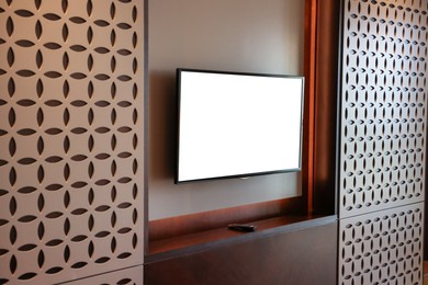 Tv set mounted on wall in room