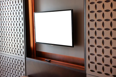 Tv set mounted on wall in room