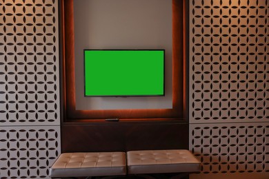 Photo of Tv set mounted on wall in room