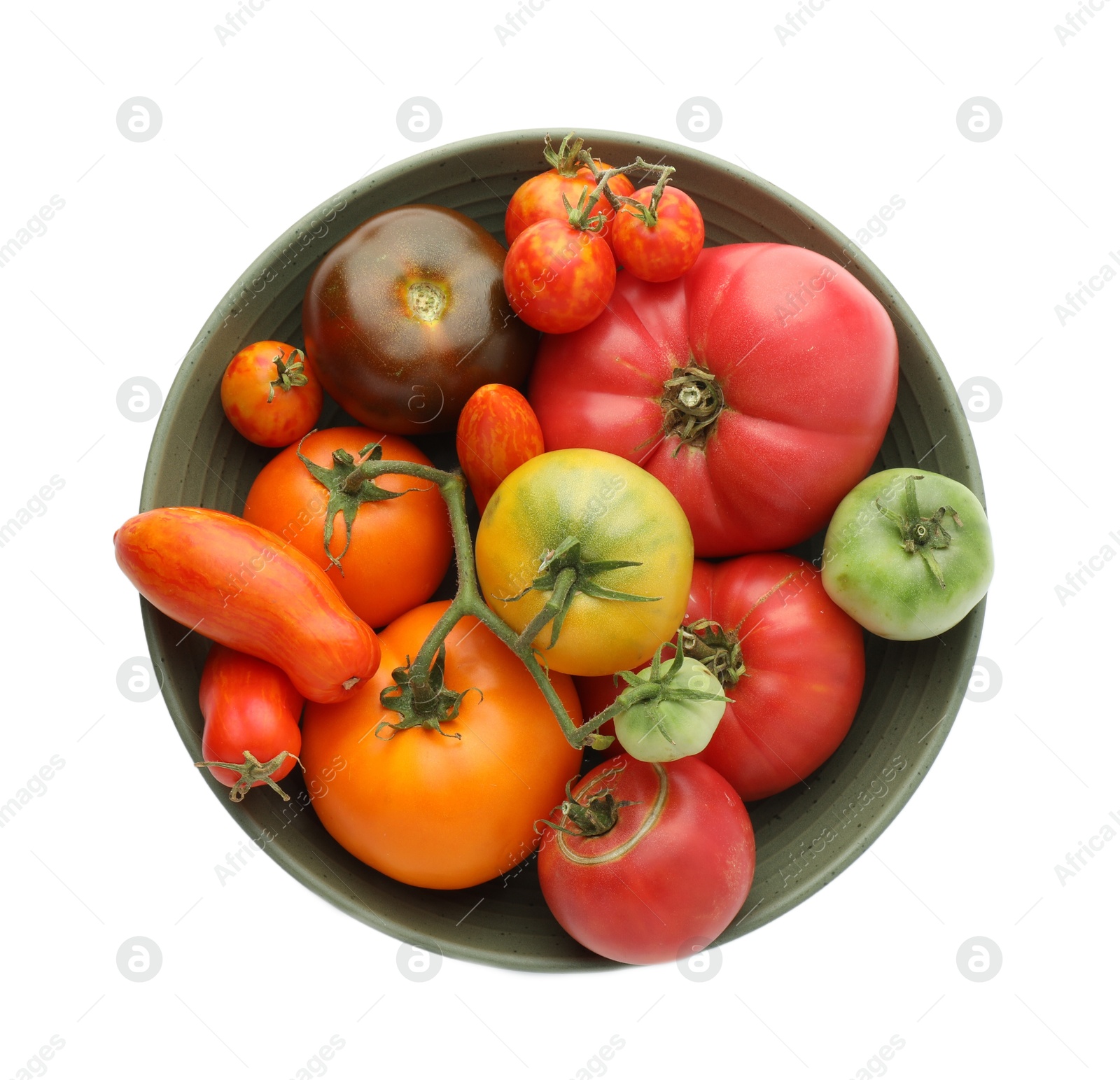 Photo of Different ripe tomatoes in bowl isolated on white, top view