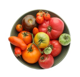 Photo of Different ripe tomatoes in bowl isolated on white, top view