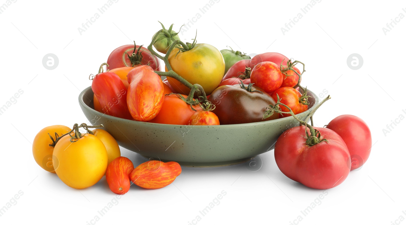 Photo of Different ripe tomatoes in bowl isolated on white