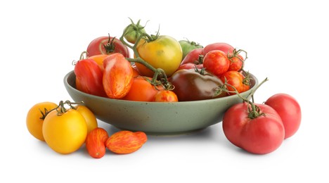 Different ripe tomatoes in bowl isolated on white