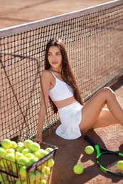 Beautiful woman in sportswear on tennis court