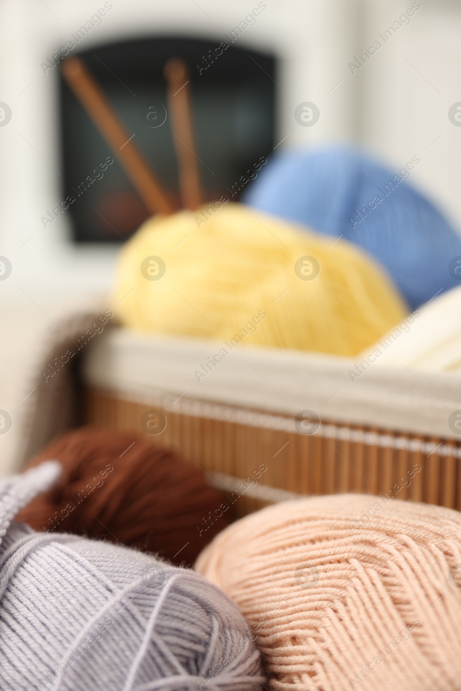 Photo of Many colorful yarns on blurred background, closeup