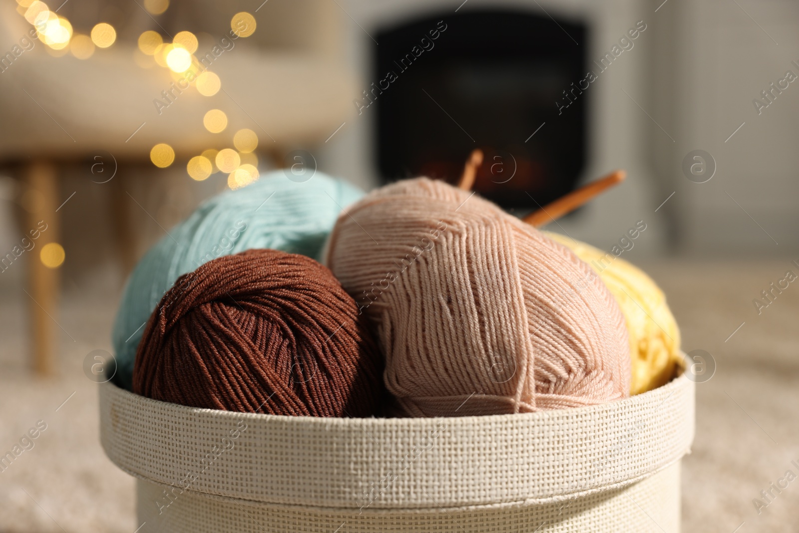 Photo of Box with colorful yarns on blurred background, closeup