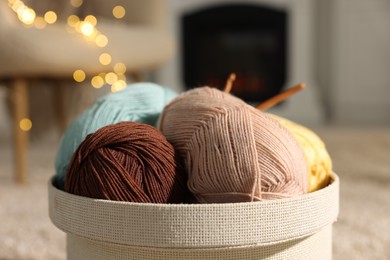 Photo of Box with colorful yarns on blurred background, closeup