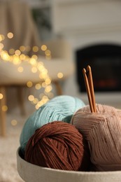 Photo of Box with colorful yarns and crochet hooks indoors, closeup