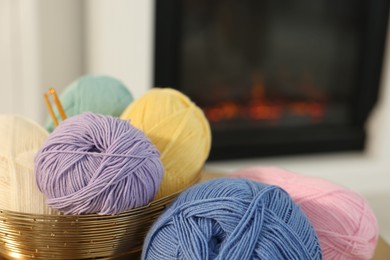 Photo of Many colorful yarns on blurred background, closeup