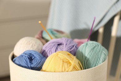 Photo of Many colorful yarns in box on blurred background, closeup