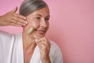 Image of Beautiful woman doing facial massage with roller on pink background. Arrows on skin showing direction of moves