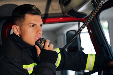 Firefighter using radio set while driving fire truck