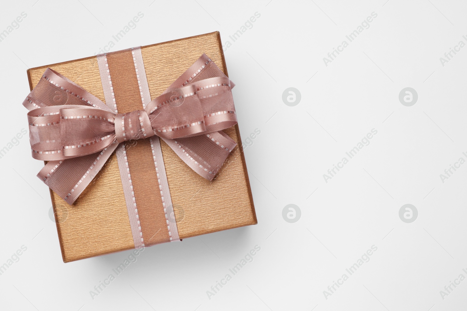 Photo of Gift box with bow on light grey background, top view. Space for text