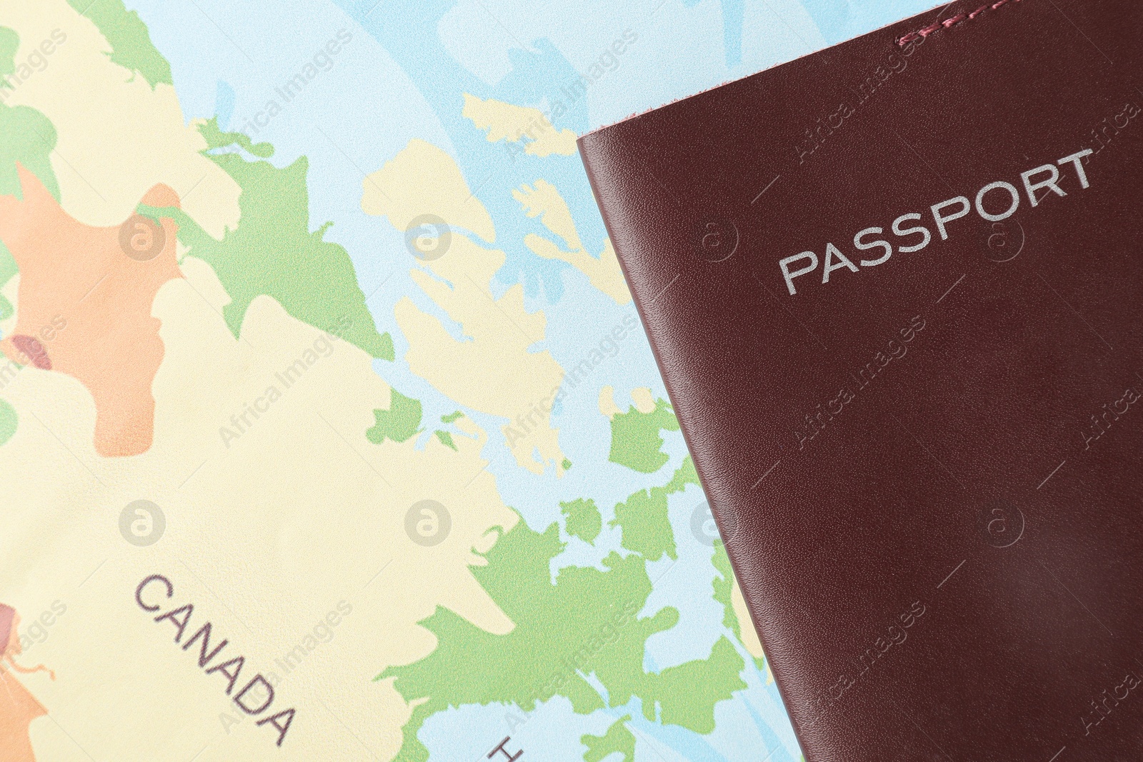 Photo of One passport on world map, top view