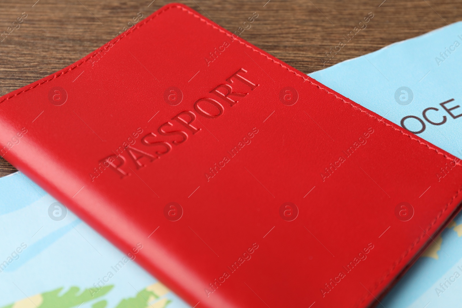 Photo of Passport and world map on wooden table