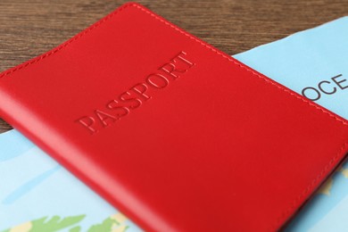 Passport and world map on wooden table