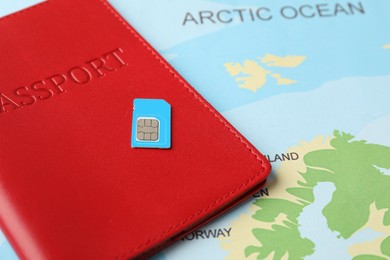 Photo of Passport and SIM card on world map, closeup