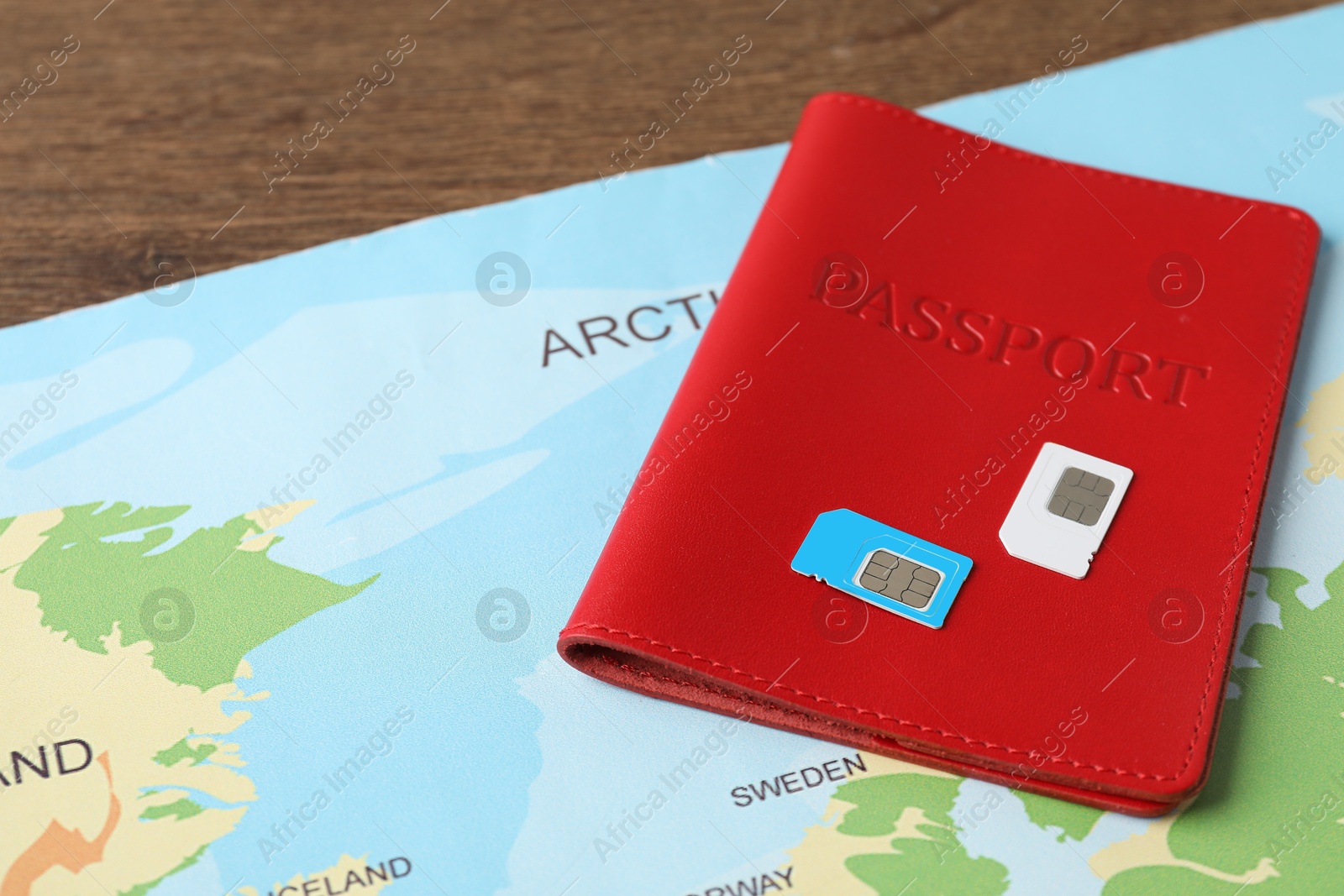 Photo of Passport, SIM cards and world map on table