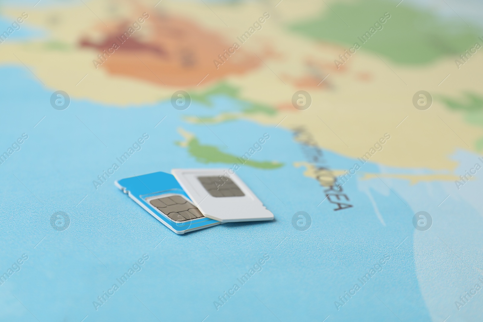 Photo of SIM cards on world map, closeup view