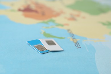 Photo of SIM cards on world map, closeup view