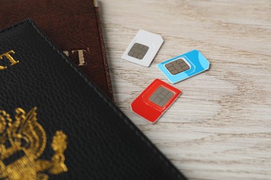 Photo of Passports and SIM cards on wooden table