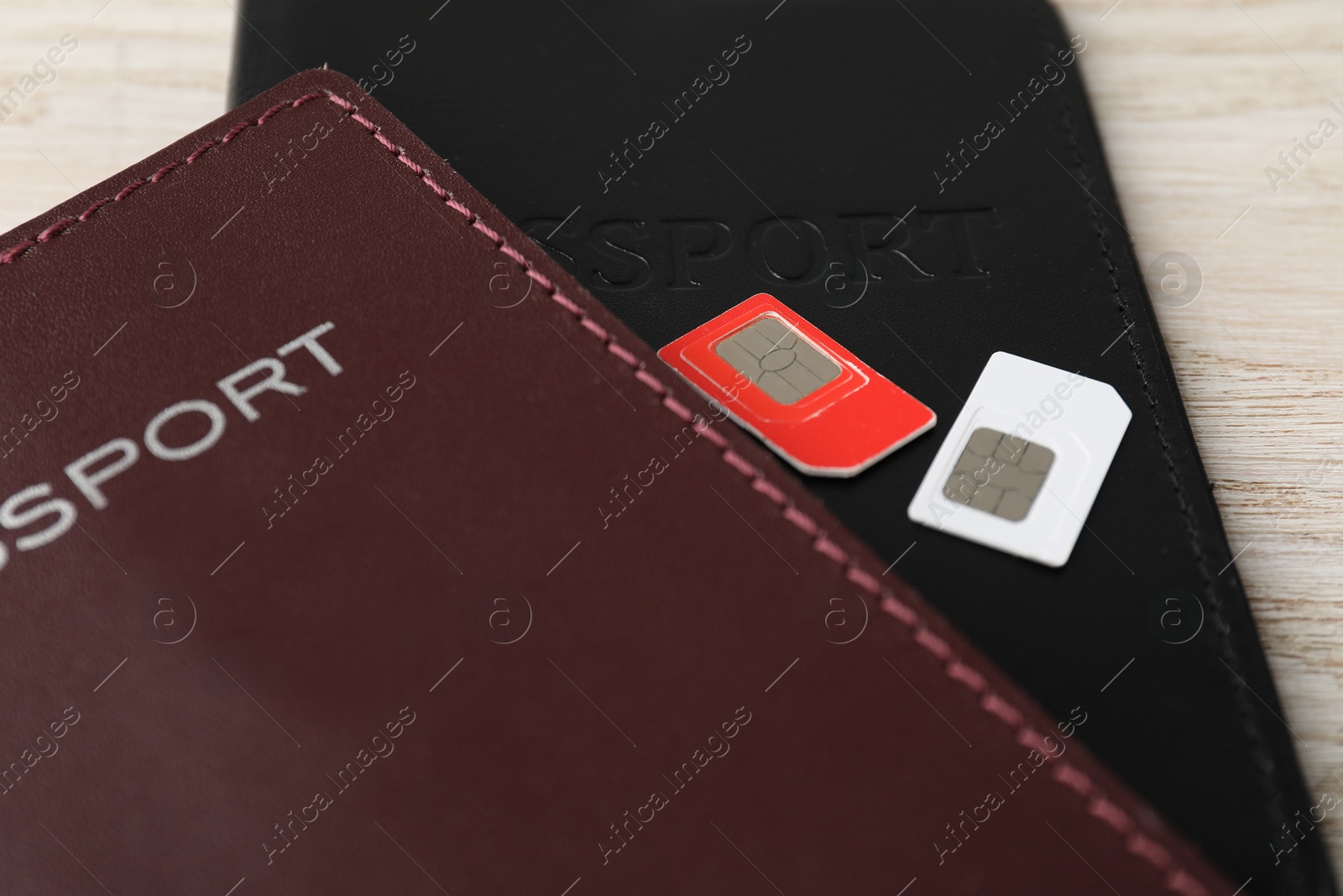 Photo of Passports and SIM cards on table, closeup